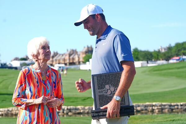 Scottie Scheffler, right, has a moment with Peggy Nelson, left, the wife of the late Byron Nelson, after Scheffler won the CJ Cup Byron Nelson golf tournament in McKinney, Texas, Sunday, May 4, 2025. (AP Photo/LM Otero)
