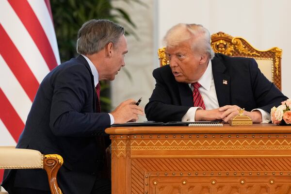 Kelly Ortberg, President and Chief Executive Officer, The Boeing Company, left, speaks President Donald Trump during a signing ceremony at the Amiri Diwan in Doha, Qatar, Wednesday, May 14, 2025. (AP Photo/Alex Brandon)