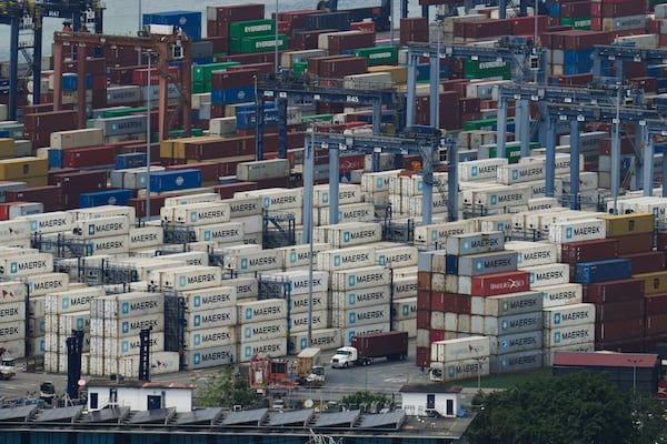 A cargo truck drives past ship containers at the Panama Canal's Balboa port, operated by Panama Port Company, in Panama City, Friday, Jan. 31, 2025. (AP Photo/Matias Delacroix)