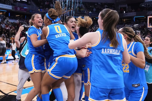 UCLA players celebrate after an NCAA college basketball game against Southern California in the championship of the Big Ten Conference tournament in Indianapolis, Sunday, March 9, 2025. (AP Photo/Michael Conroy)