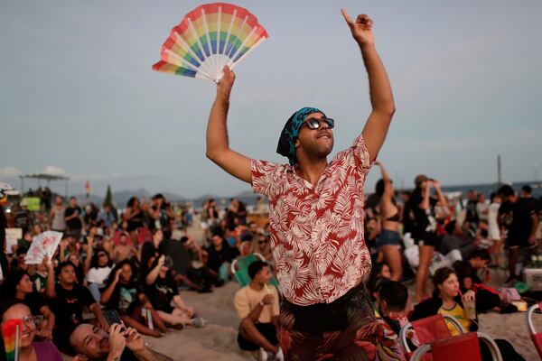 A fan cheers while waiting for the start of Lady Gaga's free concert on Copacabana beach in Rio de Janeiro, Saturday, May 3, 2025. (AP Photo/Bruna Prado)
