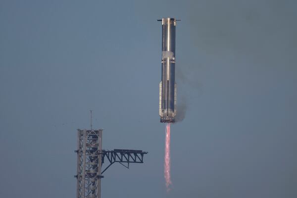 SpaceX's mega rocket Starship booster returns to the launch pad during a test flight from Starbase in Boca Chica, Texas, Thursday, Jan. 16, 2025. (AP Photo/Eric Gay)