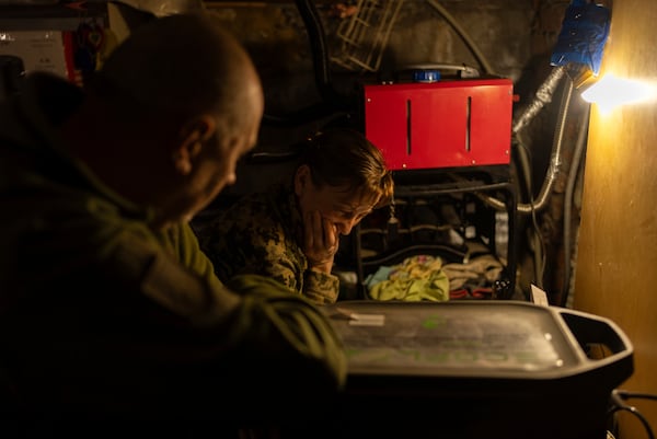 Ukrainian servicemen of Khartia brigade known by call signs "Stalker" (Left) and "Granata" (Right) are waiting for the order to fire towards Russian positions in Kharkiv region, Ukraine, Wednesday, March 12, 2025. (AP Photo/Alex Babenko)