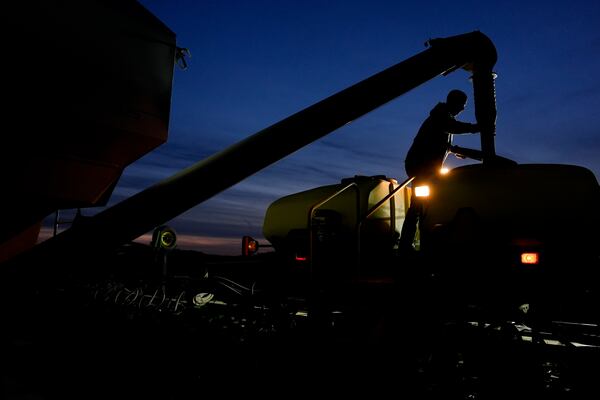 FILE - Mark Woodruff loads more soybean seeds into a planter April 22, 2024, in Sabina, Ohio. (AP Photo/Joshua A. Bickel, File)