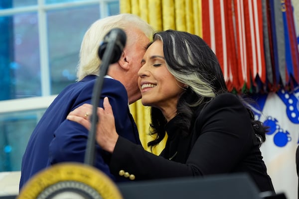 President Donald Trump congratulates Tulsi Gabbard after she was sworn in as the Director of National Intelligence in the Oval Office of the White House, Wednesday, Feb. 12, 2025, in Washington. (Photo/Alex Brandon)