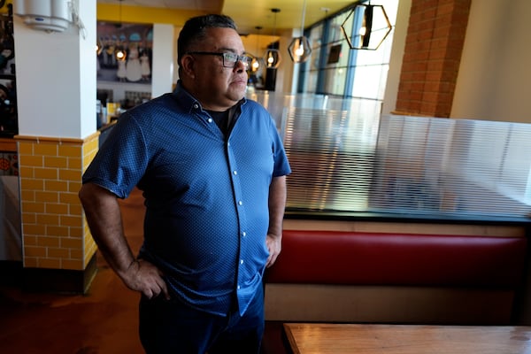 Raul Luis looks out a window at his Birrieria Chalio Mexican Restaurant in Fort Worth, Texas, Thursday, Feb. 13, 2025. (AP Photo/LM Otero)