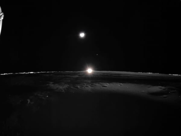 This image provided by NASA/Firefly Aerospace, Tuesday, March 18, 2025, shows the sun setting on the moon, with Earth and Venus in the distance. (NASA/Firefly Aerospace via AP)