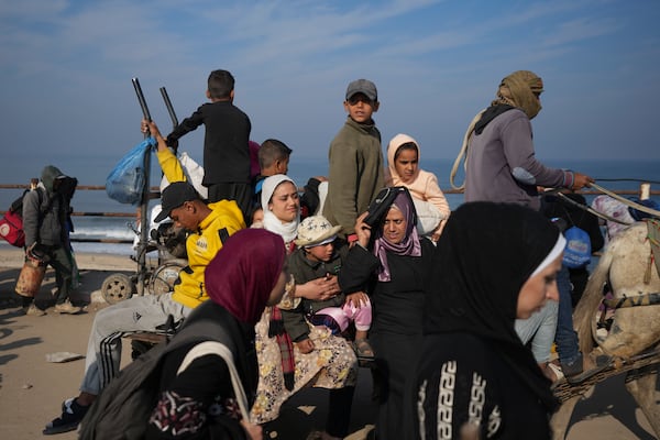 Displaced Palestinians ride in a horse-drawn cart as they return to their homes in the northern Gaza Strip, Tuesday, Jan. 28, 2025, after Israel's decision to allow thousands of them to go back for the first time since the early weeks of the 15-month war with Hamas. (AP Photo/Abdel Kareem Hana)