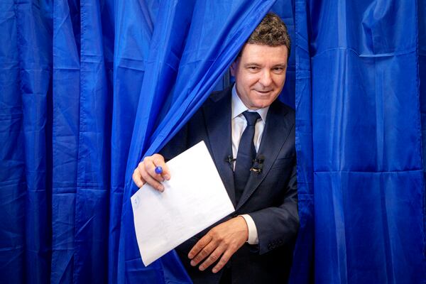 Presidential candidate Nicusor Dan exits a voting booth before casting his vote in the first round of the presidential election redo in Bucharest, Romania, Sunday, May 4, 2025. (AP Photo/Andreea Alexandru)
