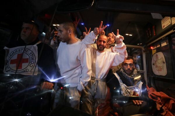 Freed Palestinian prisoners flash V-signs as they arrive in the Gaza Strip after being released from an Israeli prison following a ceasefire agreement between Hamas and Israel in Khan Younis, Gaza Strip, Thursday, Feb. 27, 2025. (AP Photo/Jehad Alshrafi)