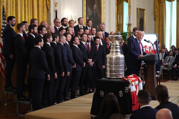 President Donald Trump speaks during an event to honor the 2024 NHL Stanley Cup champion Florida Panthers hockey team, pictured at left, in the East Room of the White House, Monday, Feb. 3, 2025, in Washington. (AP Photo/Evan Vucci)