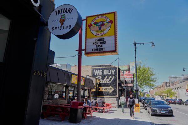 The Wiener's Circle, an iconic hot dog stand known for posting quirky phrases on its sign, posted on Instagram that its current sign translates to "He has eaten our dogs," Friday, May 9, 2025, in Chicago. (AP Photo/Erin Hooley)