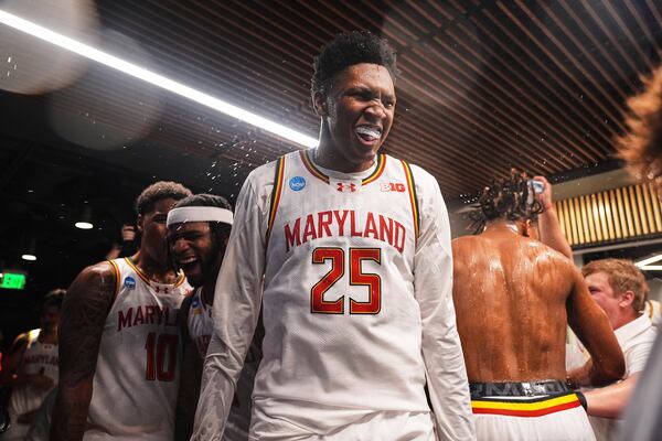 Maryland center Derik Queen celebrates with teammates after making the winning basket for a 72-71 win over Colorado State in the second round of the NCAA college basketball tournament Sunday, March 23, 2025, in Seattle. (AP Photo/Lindsey Wasson)