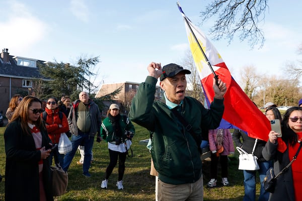 A supporter of former Philippine President Rodrigo Duterte waves a flag as he demonstrates outside the International Criminal Court detention center near The Hague in Scheveningen, Netherlands, Wednesday, March 12, 2025. (AP Photo/Omar Havana)