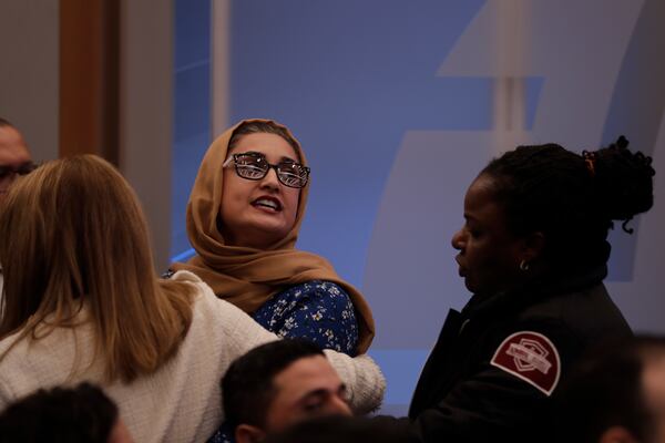 A protestor interrupts Secretary of State Antony Blinken speech at the Atlantic Council, Tuesday, Jan. 14, 2025, in Washington. (AP Photo/Luis M. Alvarez)