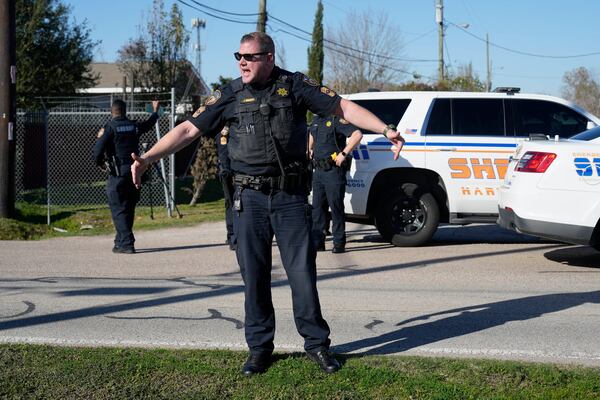 FILE - Harris County Sheriff's officers clear the media from the neighborhood where 42-year-old suspect Shamsud-Din Bahar Jabbar is believed to have lived, Wednesday, Jan. 1, 2025, in Houston. (AP Photo/David J. Phillip, File)