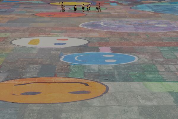 An Ariel view of the canvas painting by Kanyeyachukwu Tagbo-Okeke, a 15-year-old autistic artist who won the Guinness World Record for the largest art canvas, on display at the Eagle Square on World Autism Day in Abuja, Nigeria, Wednesday, April 2, 2025. (AP Photo/David Durowaiye)