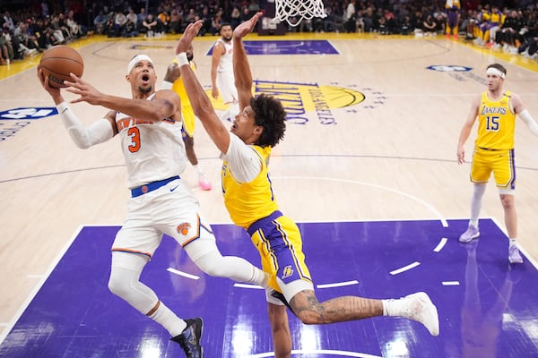 New York Knicks guard Josh Hart, left, shoots as Los Angeles Lakers center Jaxson Hayes defends during the first half of an NBA basketball game Thursday, March 6, 2025, in Los Angeles. (AP Photo/Mark J. Terrill)