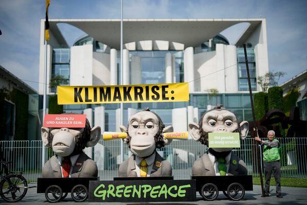 FILE - Activists of the environment organization Greenpeace protest against the climate policy of the German government in front of the chancellery, prior to the cabinet meeting in Berlin, Germany, Wednesday, June 21, 2023. (AP Photo/Markus Schreiber,File)