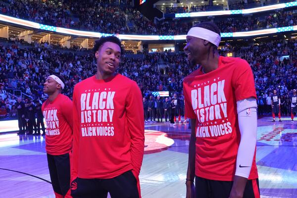 From left to right, Toronto Raptors forwards Bruce Brown, Scottie Barnes and Chris Boucher react as fans boo the United States national anthem before NBA basketball game action against the Los Angeles Clippers in Toronto, Sunday, Feb. 2, 2025. (Frank Gunn/The Canadian Press via AP)