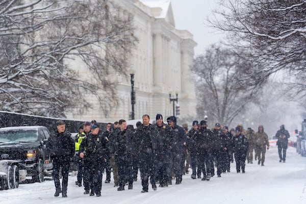 Police from nearby Arlington, Va., arrive at the Capitol to help reinforce the security presence ahead of a joint session of Congress to certify the votes from the Electoral College in the presidential election, in Washington, Monday, Jan. 6, 2025. (AP Photo/J. Scott Applewhite)