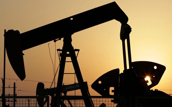 FILE - Oil pumps work in the desert oil fields of Sakhir, Bahrain, Sept. 30, 2015. (AP Photo/Hasan Jamali, File)