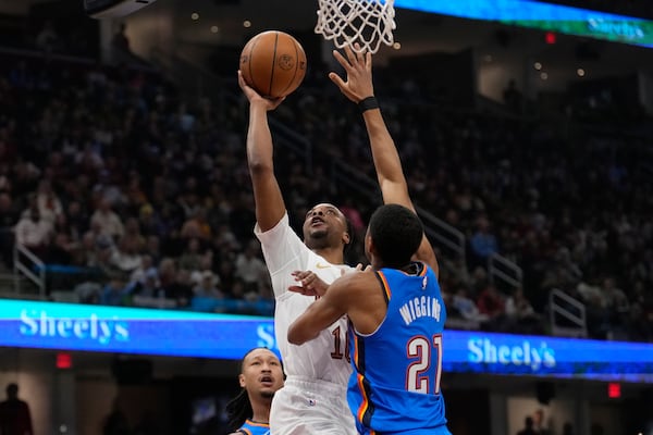 Cleveland Cavaliers guard Darius Garland shoots as Oklahoma City Thunder guard Aaron Wiggins (21) defends in the first half of an NBA basketball game, Wednesday, Jan. 8, 2025, in Cleveland. (AP Photo/Sue Ogrocki)