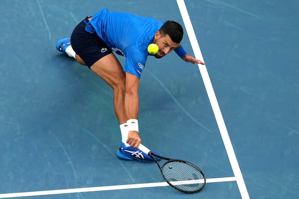 Novak Djokovic of Serbia returns a shot from Jiri Lehecka of the Czech Republic during their fourth round match at the Australian Open tennis championship in Melbourne, Australia, Sunday, Jan. 19, 2025. (AP Photo/Mark Baker)