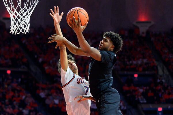 Illinois' Will Riley attempts to block Michigan State's Jase Richardson during the second half of an NCAA college basketball game Saturday, Feb. 15, 2025, in Champaign, Ill. (AP Photo/Craig Pessman)