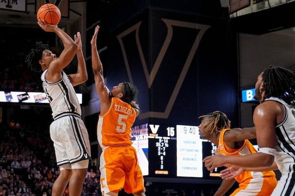 Vanderbilt guard AJ Hoggard, left, shoots the ball over Tennessee guard Zakai Zeigler (5) during the first half of an NCAA college basketball game Saturday, Jan. 18, 2025, in Nashville, Tenn. (AP Photo/George Walker IV)