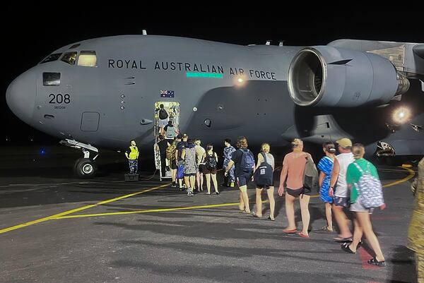 In this photo released by Australia's Department of Foreign Affairs and Trade (DFAT), Australians board a Royal Australian Air Force aircraft in Port Vila, Vanuatu in the early hours of Thursday, Dec. 19, 2024, following a powerful earthquake that struck just off the coast of Vanuatu in the South Pacific Ocean, Tuesday, Dec. 17, 2024. (DFAT via AP)