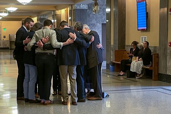 FILE - Covenant School parents and their attorneys huddle in prayer outside a courtroom before a hearing to decide whether documents and journals of a Nashville school shooter can be released to the public, April 17, 2024, in Nashville, Tenn. (AP Photo/Travis Loller, File)