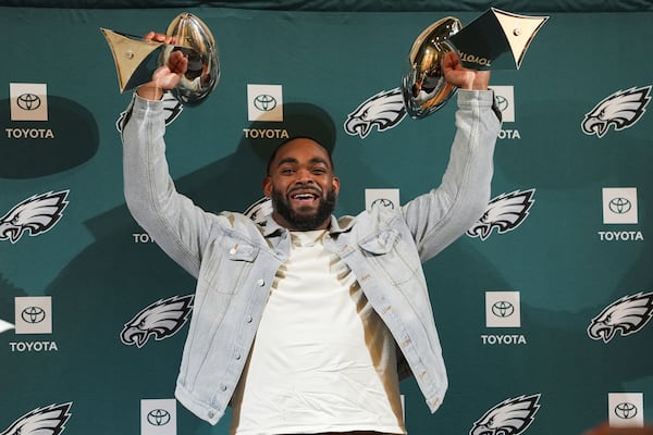 Brandon Graham holds up two Lombardi Trophies during a news conference announcing his retirement, Tuesday, March 18, 2025, at the Philadelphia Eagles' NFL football training facility in Philadelphia. (AP Photo/Matt Rourke