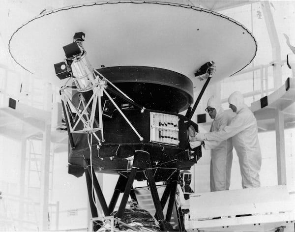 FILE - This photo provided by NASA shows the "Sounds of Earth" record being mounted on the Voyager 2 spacecraft in the Safe-1 Building at the Kennedy Space Center, Fla. Aug. 4, 1977. (NASA via AP, File)