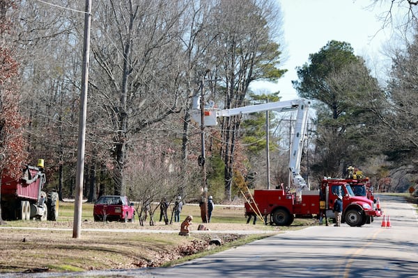 Crews with Tombigbee Electric continue to restore power to homes along Lee County Rd 154 after Saturday's severe weather hit the region in Shannon Miss., Monday, Feb. 17, 2025. (Thomas Wells/The Northeast Mississippi Daily Journal via AP)