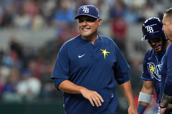 Tampa Bay Rays manager Kevin Cash, left, walks back to the dugout after checking on José Caballero during the seventh inning of a baseball game against the Texas Rangers, Saturday, April 5, 2025, in Arlington, Texas. (AP Photo/LM Otero)