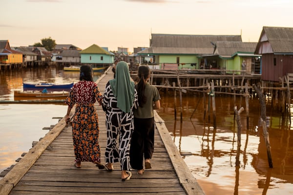 People walk through Baliara village on Kabaena Island in South Sulawesi, Indonesia, Friday, Nov. 15, 2024. (AP Photo/Yusuf Wahil)