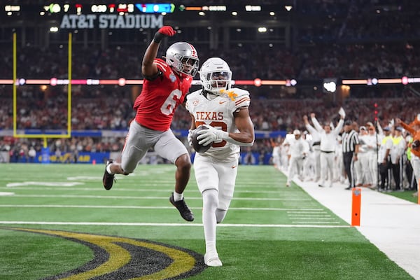 Texas running back Jaydon Blue, foreground, catches a touchdown pass against Ohio State safety Sonny Styles (6) during the first half of the Cotton Bowl College Football Playoff semifinal game, Friday, Jan. 10, 2025, in Arlington, Texas. (AP Photo/Julio Cortez)