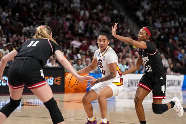 South Carolina guard Te-Hina Paopao (0) is defended by Indiana forward Karoline Striplin (11) and guard Chloe Moore-McNeil (22) during the first half in the second round of the NCAA college basketball tournament, Sunday, March 23, 2025, in Columbia, S.C. (AP Photo/David Yeazell)