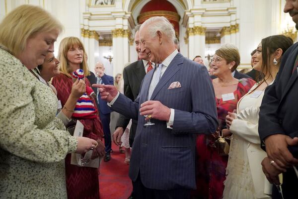 Britain's King Charles III speaks to guests during a reception in Buckingham Palace, London, in celebration of community-based initiatives raising awareness about cancer and supporting those living with cancer, Wednesday April 30, 2025. (Yui Mok/Pool Photo via AP)