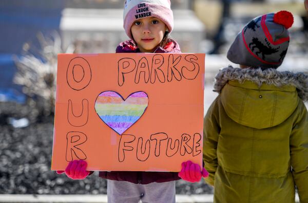 Dahlia Alvarado, 6, holds a sign in support of the National Park Service at a "Save Steamtown" rally to protest the Trump administration layoffs at the Steamtown National Historic Site in Scranton, Pa., Saturday, Feb. 22, 2025. (Aimee Dilger/WVIA via AP)