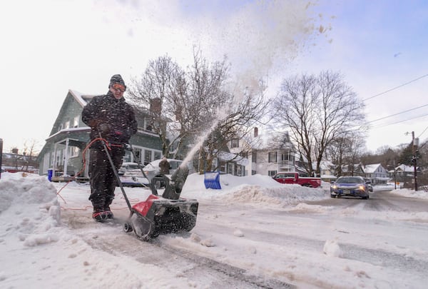 Jim Verzino uses a snowblower to clear the driveway on Monday, Feb. 17, 2025, Brattleboro, Vt., after a winter storm on Sunday. (Kristopher Radder/The Brattleboro Reformer via AP)