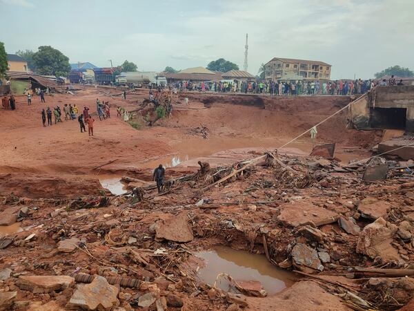People search in flooded area following a downpour in Mokwa, Nigeria, Friday, May 30, 2025. (AP Photo/Chenemi Bamaiyi)