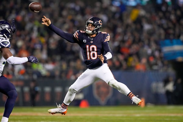 Chicago Bears quarterback Caleb Williams attempts a pass against the Seattle Seahawks during the first half of an NFL football game, Thursday, Dec. 26, 2024, in Chicago. (AP Photo/Nam Y. Huh)