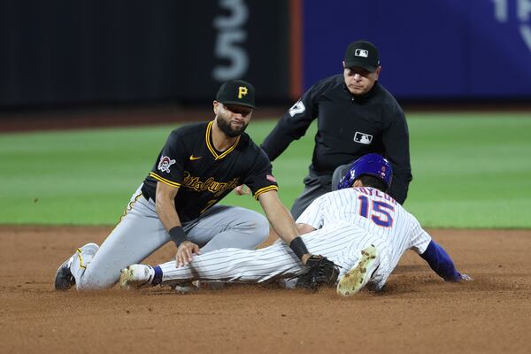 New York Mets' Tyrone Taylor (15) steals second base against Pittsburgh Pirates shortstop Isiah Kiner-Falefa, left, during the seventh inning of a baseball game Monday, May 12, 2025, in New York. (AP Photo/Pamela Smith)