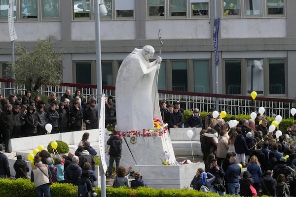 Faithful pray for Pope Francis outside the Agostino Gemelli polyclinic in Rome, Sunday, March 16, 2025. (AP Photo/Gregorio Borgia)