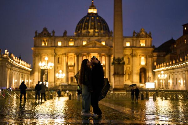 A couple kiss in St. Peter's Square at The Vatican, Wednesday, March 12, 2025. (AP Photo/Francisco Seco)