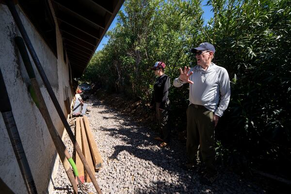 Dr. Jack Cohen, a former fire research scientist for the U.S. Forest Service, right, asseses the exterior condition of a house, Tuesday, Feb. 25, 2025, in Kamuela, Hawaii. (AP Photo/Mengshin Lin)