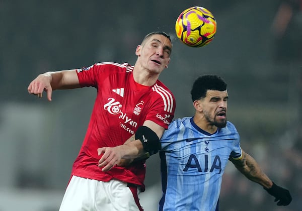 Nottingham Forest's Nikola Milenkovic and Tottenham Hotspur's Dominic Solanke, right, challenge for the ball during the English Premier League soccer match between Nottingham Forest and Tottenham Hotspur at the City Ground stadium in Nottingham, England, Thursday, Dec. 26, 2024. (Mike Egerton/PA via AP)