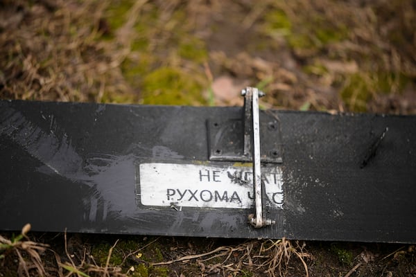 A part of an Ukrainian drone lies on the ground near an apartment building where a downed Ukrainian drone fell in Sapronovo village outside Moscow, Russia, on Tuesday, March 11, 2025. (AP Photo)